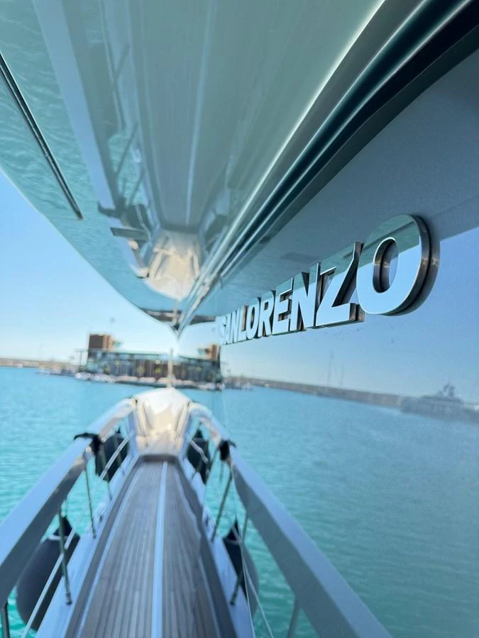 A close-up view of the yacht's sleek exterior with a focus on the brand name and the surrounding water. aboard BELLA B Yacht for Sale