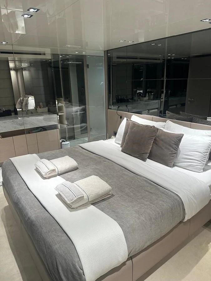 A luxurious stateroom featuring a plush bed with neatly arranged linens and pillows. aboard BELLA B Yacht for Sale