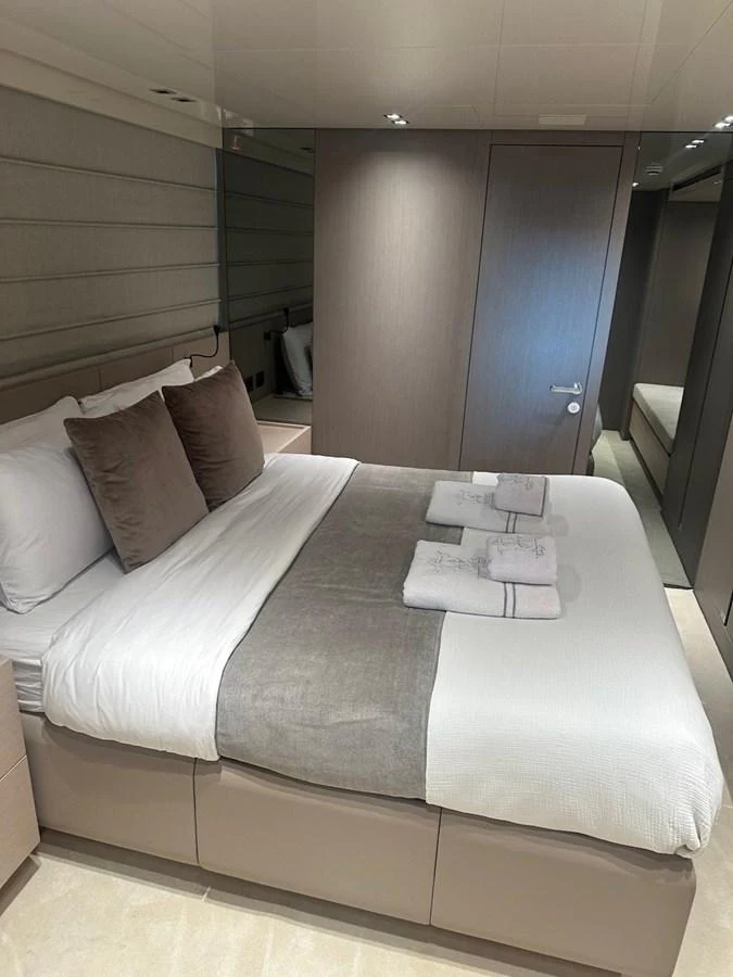 The stateroom features a plush bed with elegant linens and modern decor. aboard BELLA B Yacht for Sale