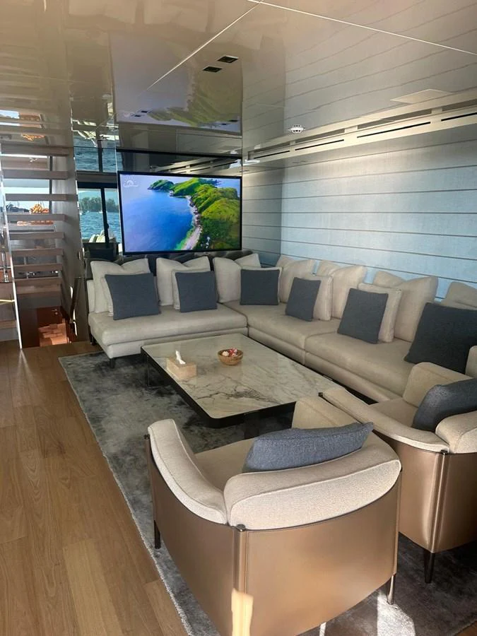 The salon offers a comfortable and stylish seating area with a large TV and modern decor. aboard BELLA B Yacht for Sale