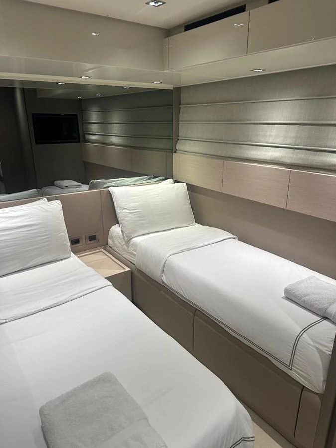 The twin stateroom offers a cozy and modern sleeping area with two single beds and elegant decor. aboard BELLA B Yacht for Sale