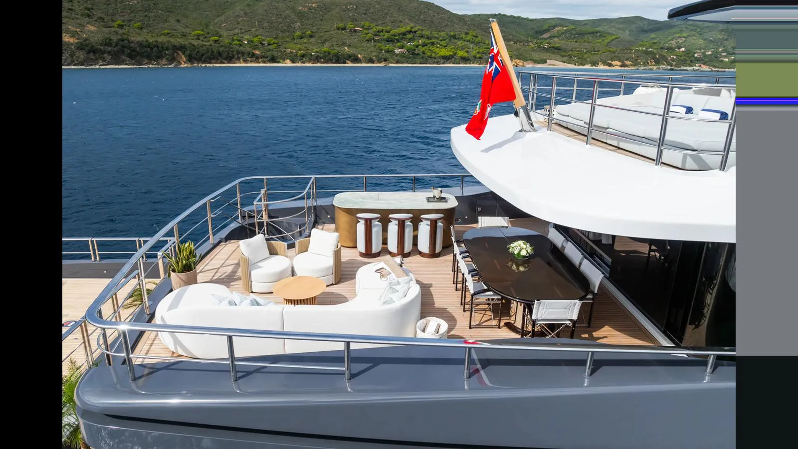 The aft deck offers a luxurious outdoor seating and dining area with stunning views of the surrounding waters. aboard BIG SHARK Yacht for Sale