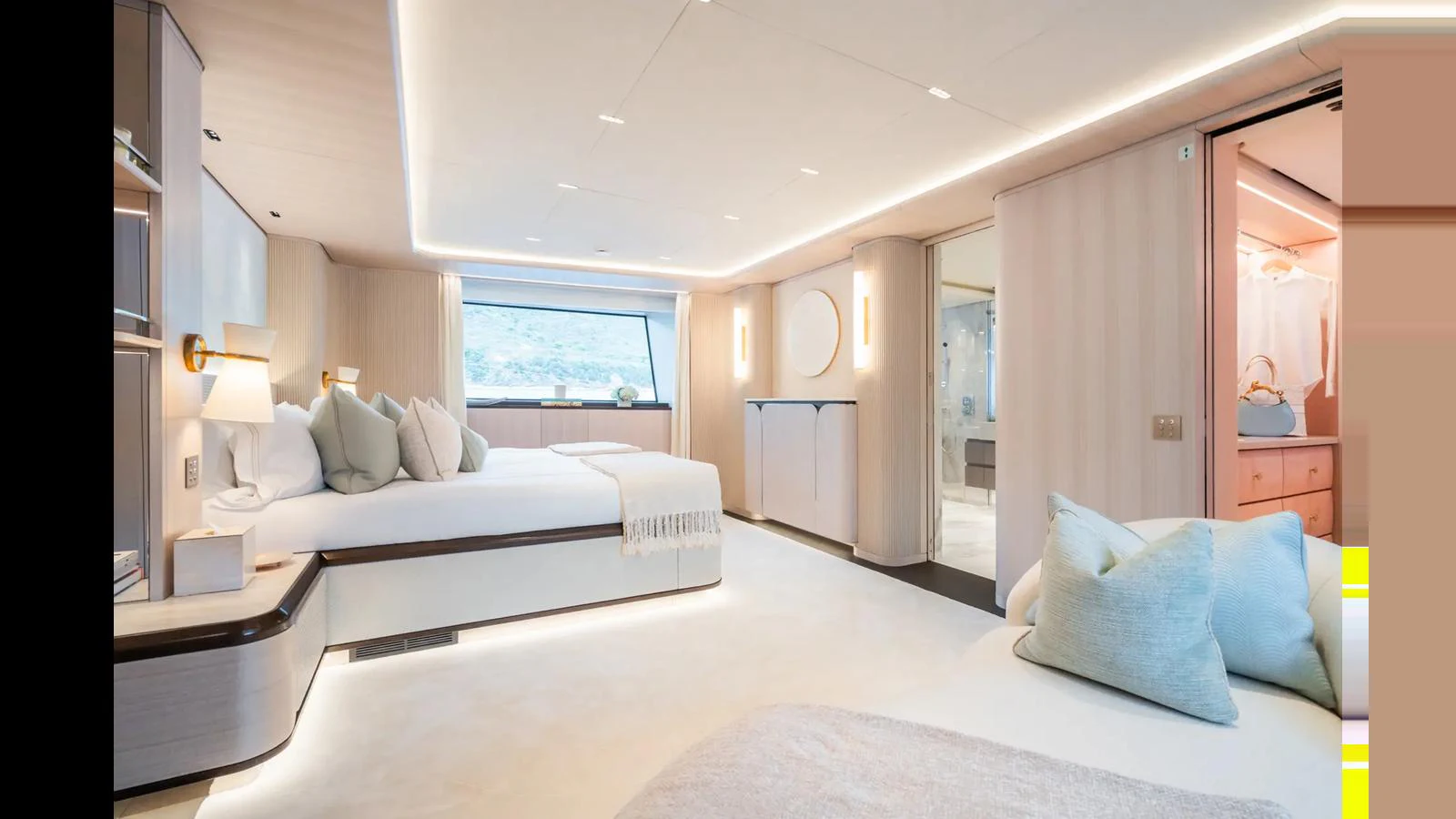The master stateroom features a spacious and elegantly designed layout with luxurious bedding and modern lighting. aboard BIG SHARK Yacht for Sale