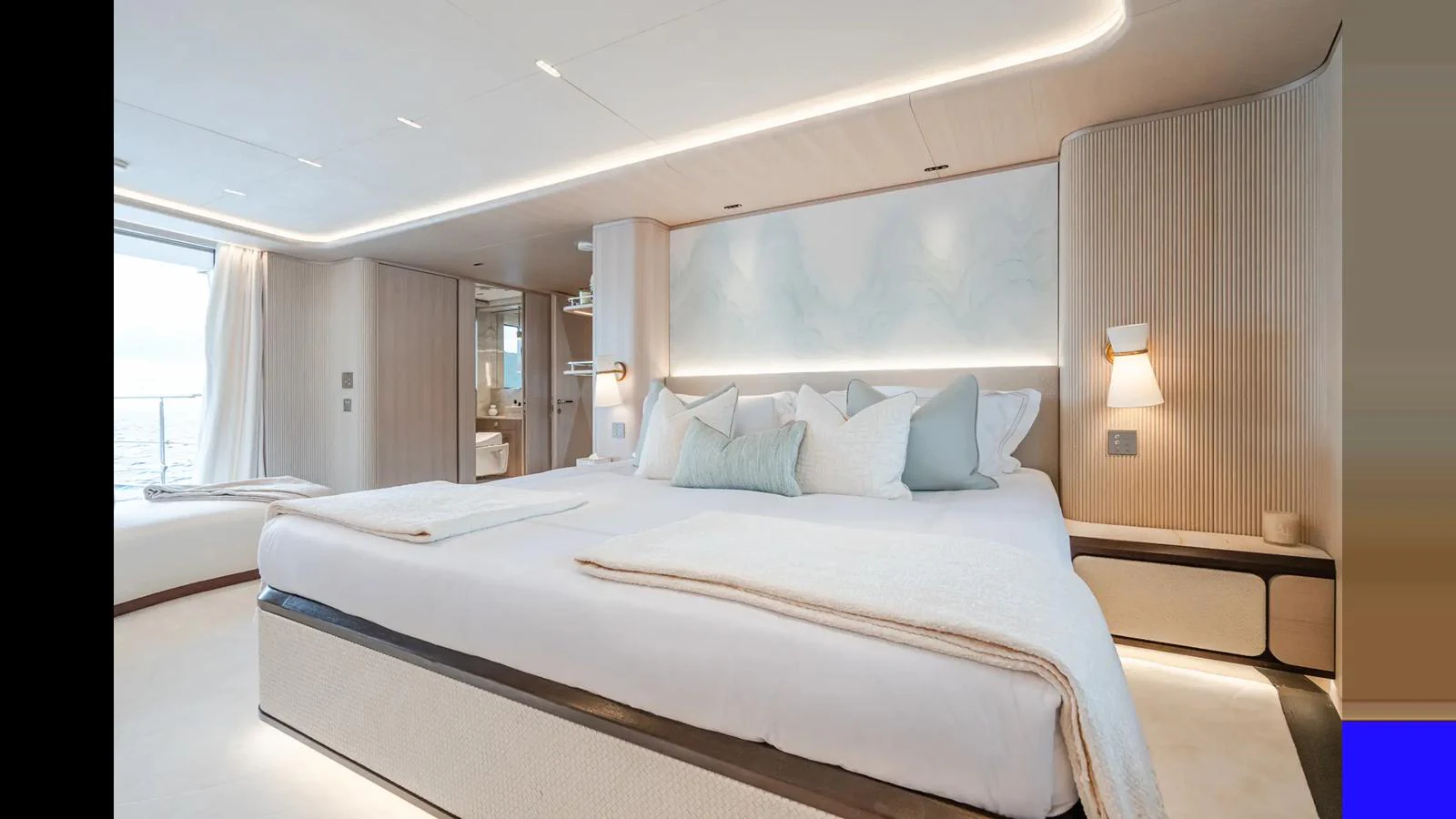The master stateroom features a luxurious bed with elegant lighting and modern decor. aboard BIG SHARK Yacht for Sale