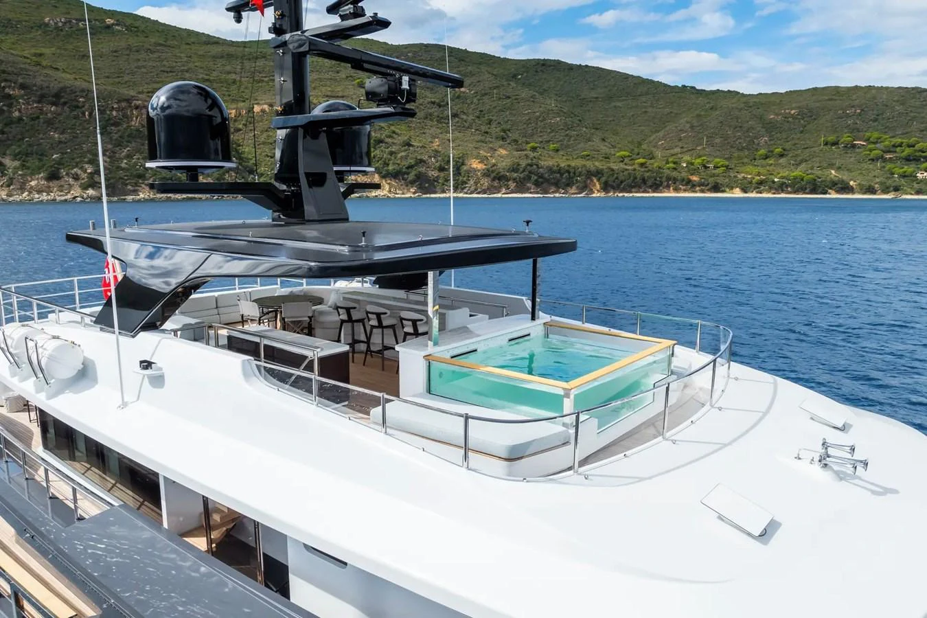 The yacht's sundeck features a luxurious pool with stunning views of the surrounding waters and landscape. aboard BIG SHARK Yacht for Sale