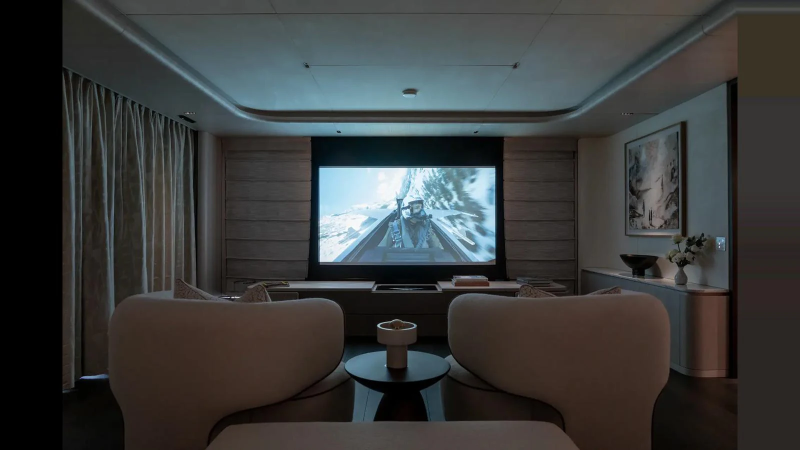 The yacht's media room offers a luxurious space for entertainment with a large screen and comfortable seating. aboard BIG SHARK Yacht for Sale