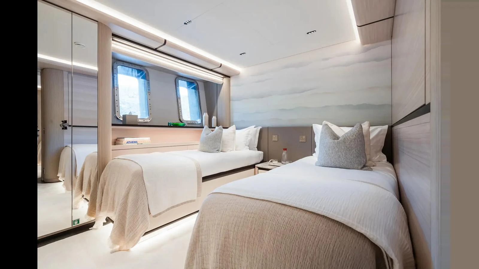 The guest stateroom features twin beds and a serene ambiance with soft lighting and elegant decor. aboard BIG SHARK Yacht for Sale