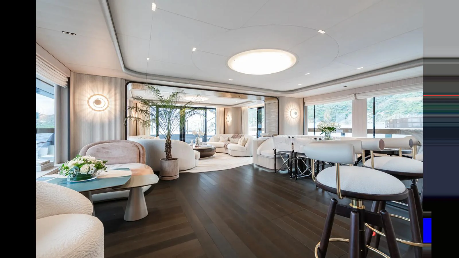 The yacht's interior features a spacious and elegantly designed living area with modern furnishings and ample natural light. aboard BIG SHARK Yacht for Sale