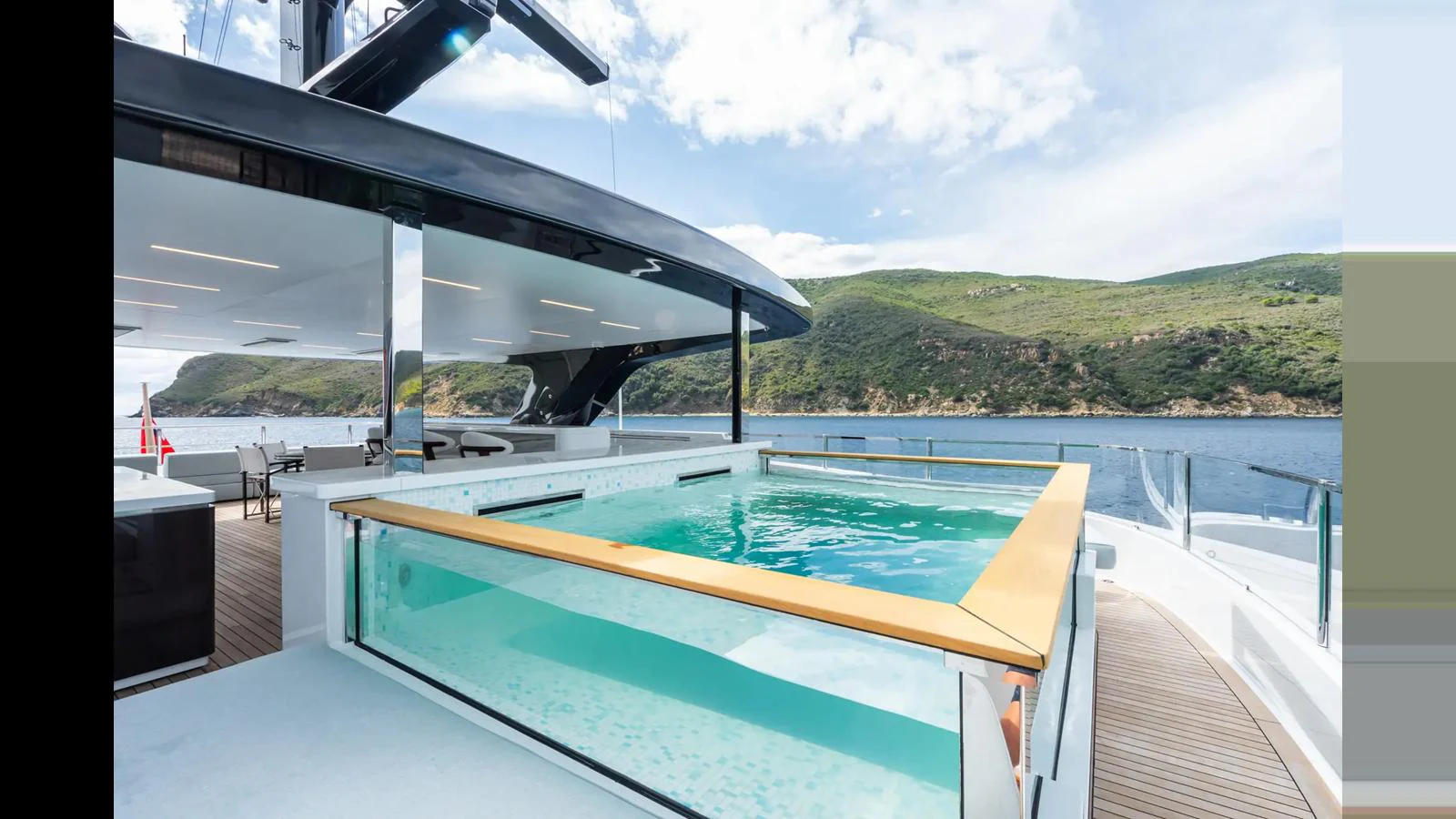 The sundeck features a luxurious pool with stunning views of the surrounding landscape. aboard BIG SHARK Yacht for Sale