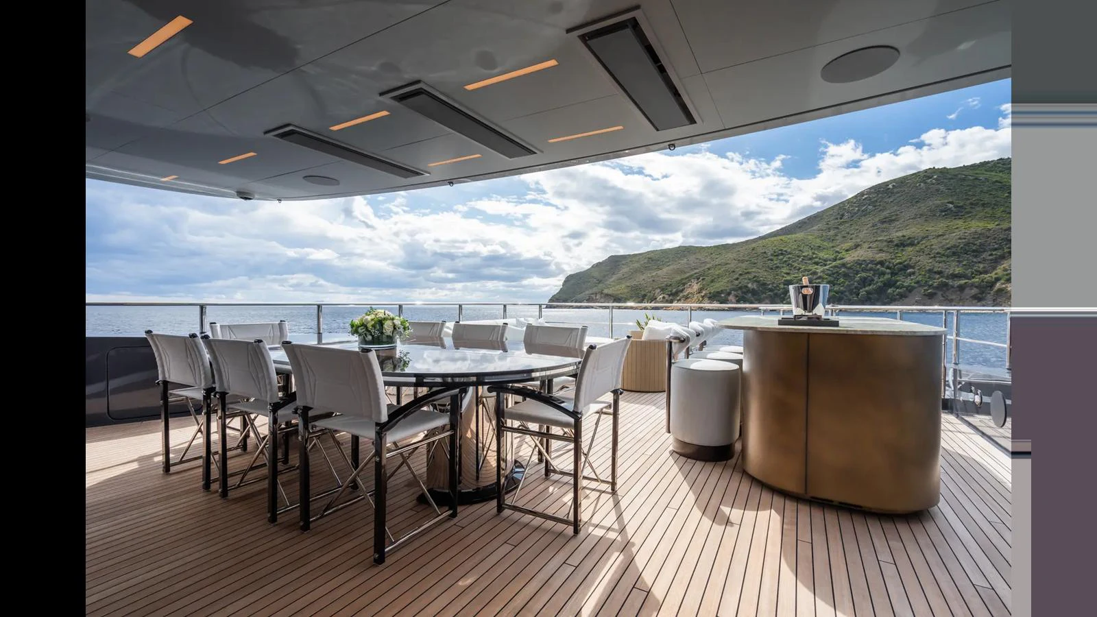 The aft deck features a spacious dining area with stunning views of the surrounding seascape. aboard BIG SHARK Yacht for Sale