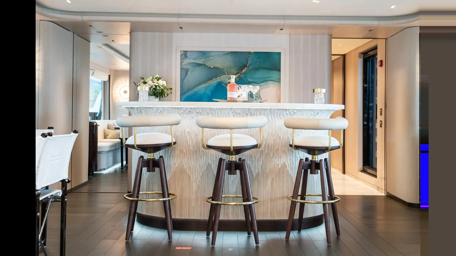 The yacht's interior features a stylish bar area with modern seating and elegant decor. aboard BIG SHARK Yacht for Sale