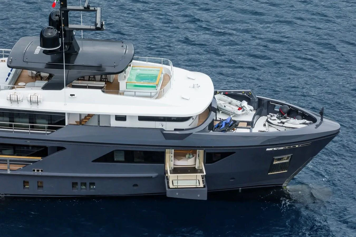 A sleek yacht with a modern design, featuring a sundeck with a jacuzzi and a tender on the bow. aboard BIG SHARK Yacht for Sale