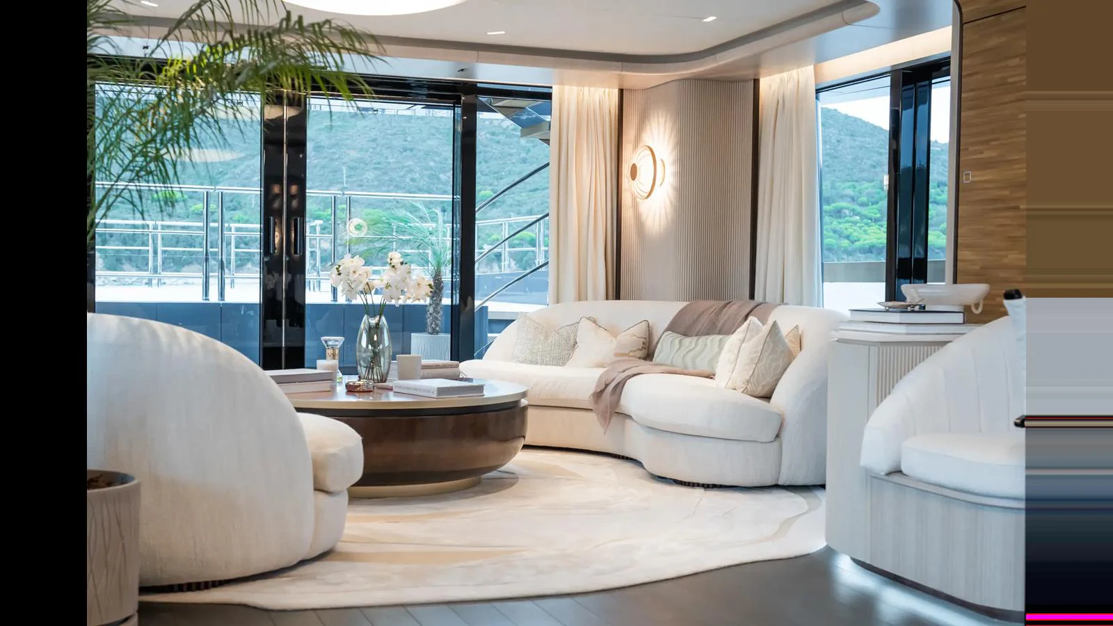 The salon features elegant, modern furnishings with large windows offering stunning views. aboard BIG SHARK Yacht for Sale