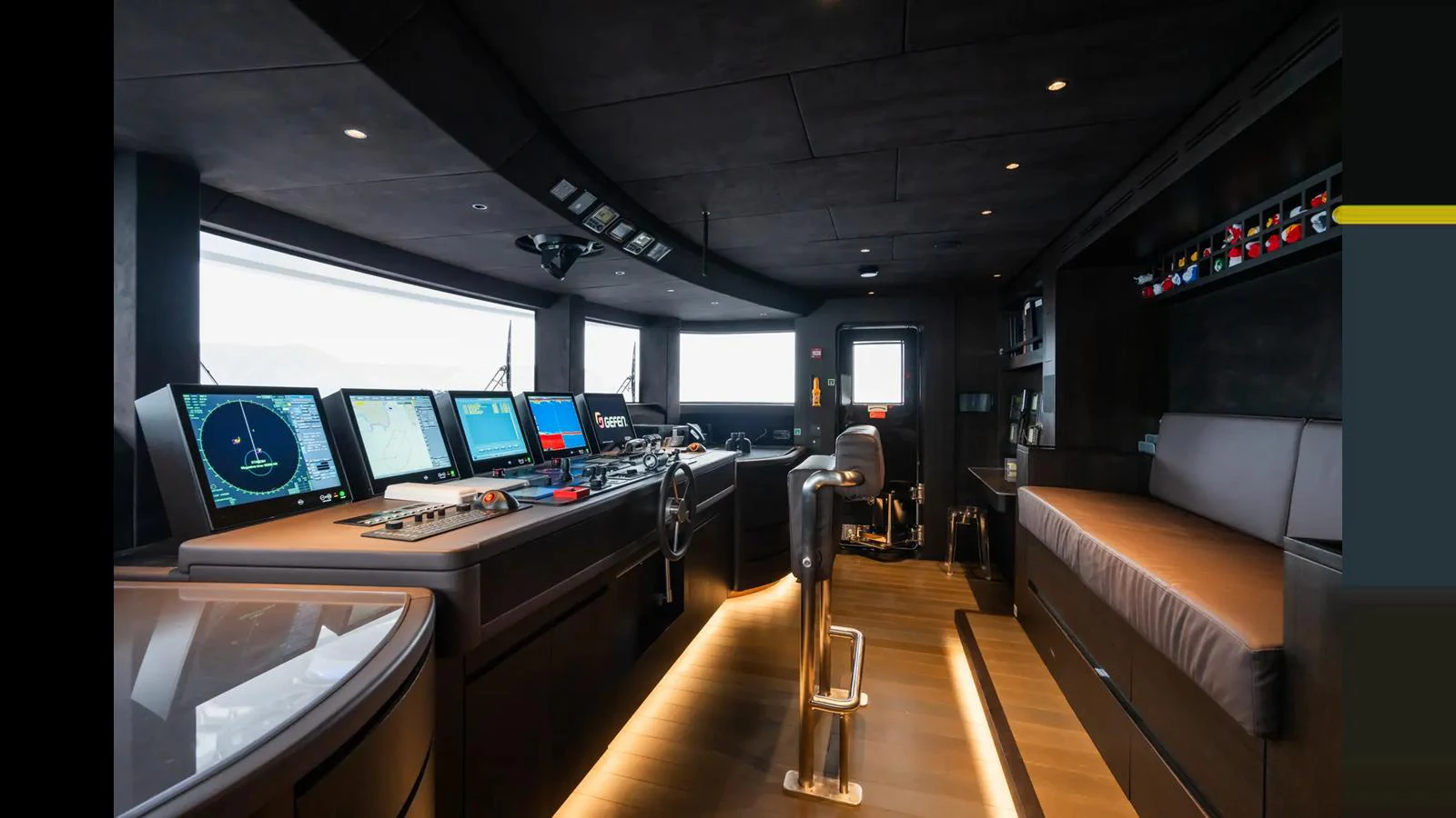 The helm of the yacht features advanced navigation equipment and a sleek, modern design. aboard BIG SHARK Yacht for Sale