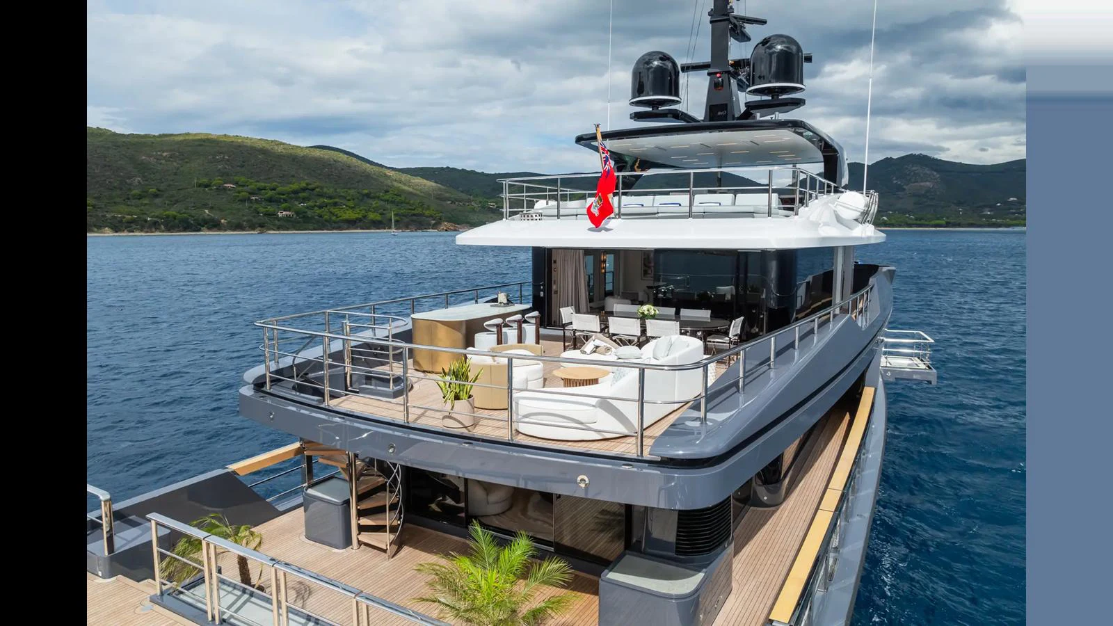 The yacht's aft deck offers a spacious and luxurious outdoor living area with stunning views of the surrounding waters. aboard BIG SHARK Yacht for Sale