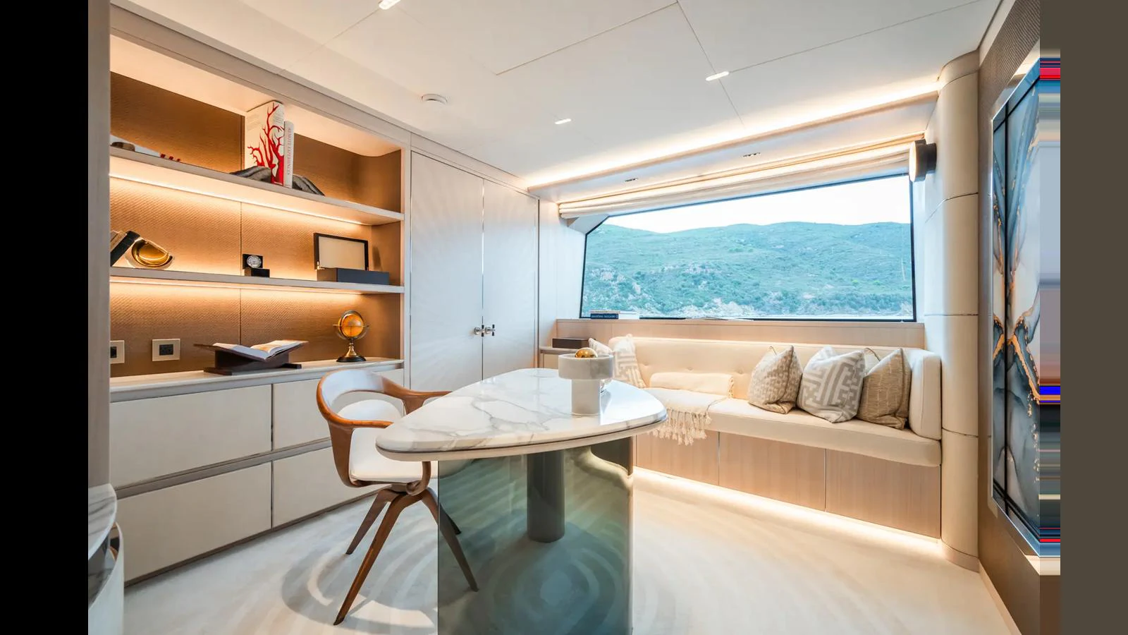 A luxurious yacht interior featuring a comfortable seating area and a stylish table. aboard BIG SHARK Yacht for Sale