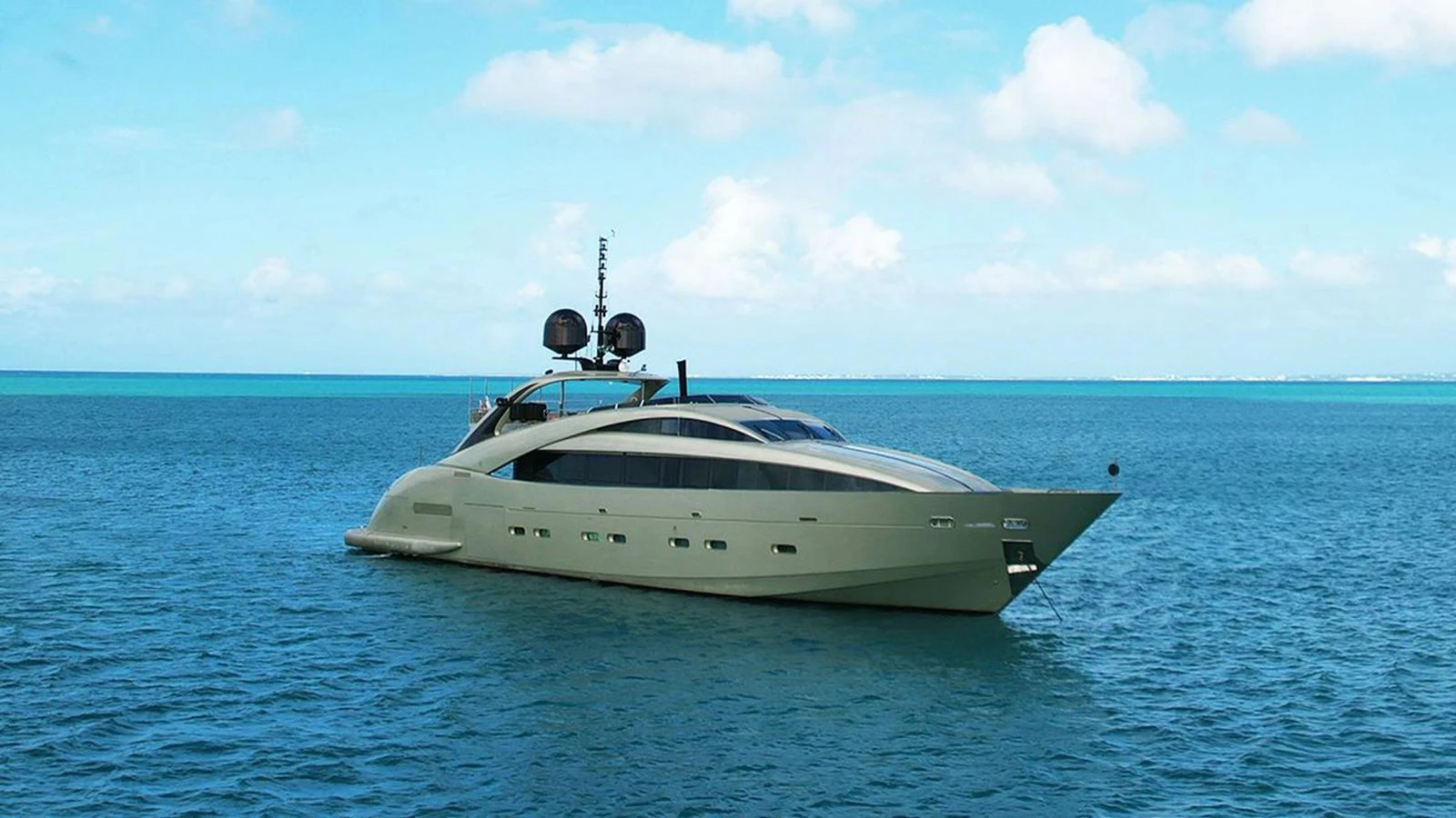 A sleek and modern yacht cruising on tranquil blue waters under a bright sky. aboard YCM 120 Yacht for Sale