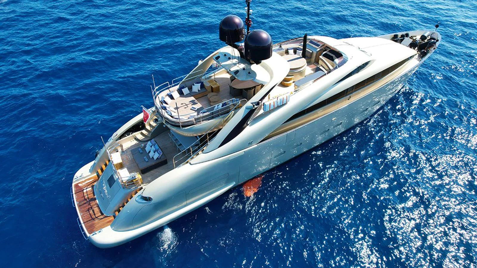 A sleek and modern yacht glides through the deep blue waters, showcasing its luxurious design and spacious decks. aboard YCM 120 Yacht for Sale