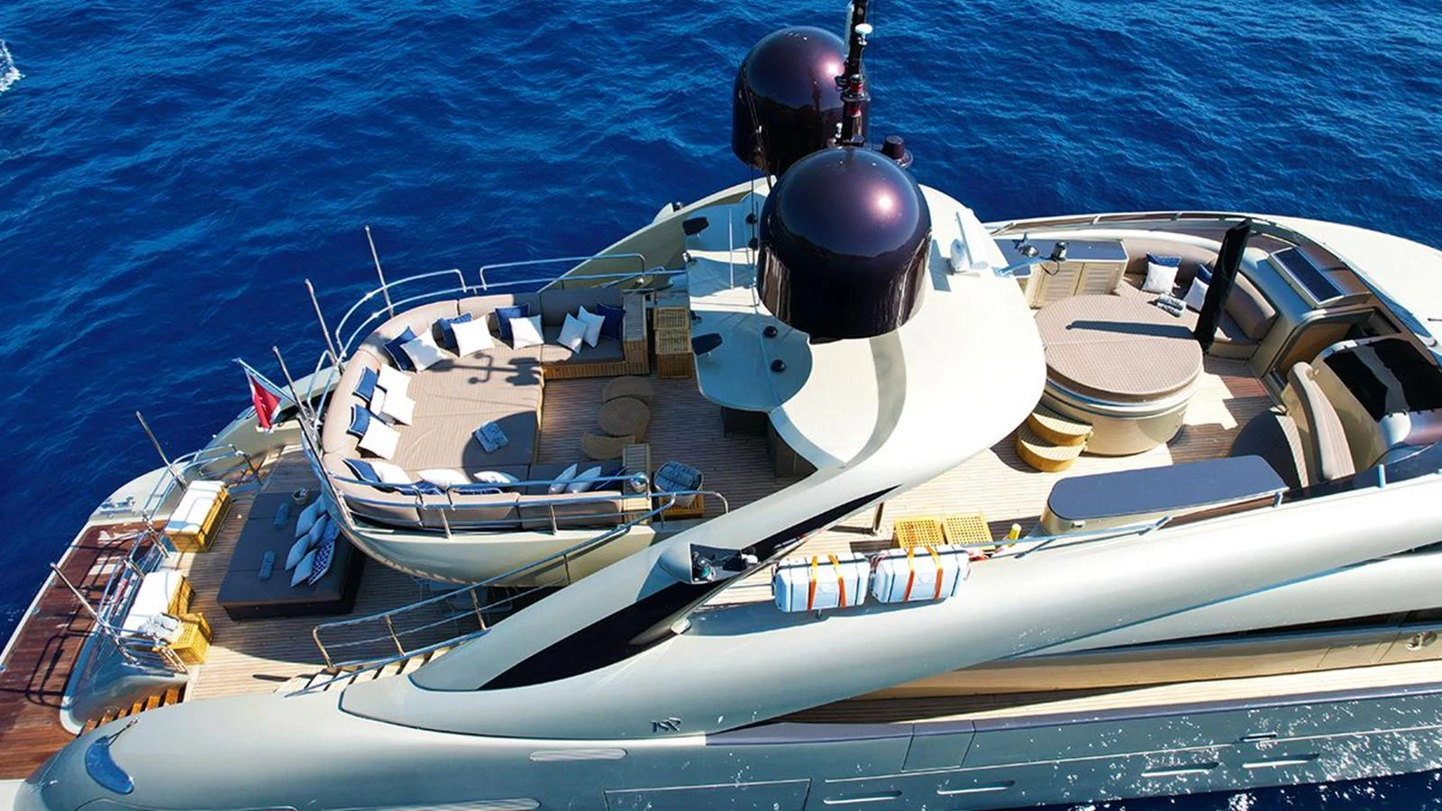 The yacht's sundeck offers luxurious lounging areas with stunning views over the water. aboard YCM 120 Yacht for Sale