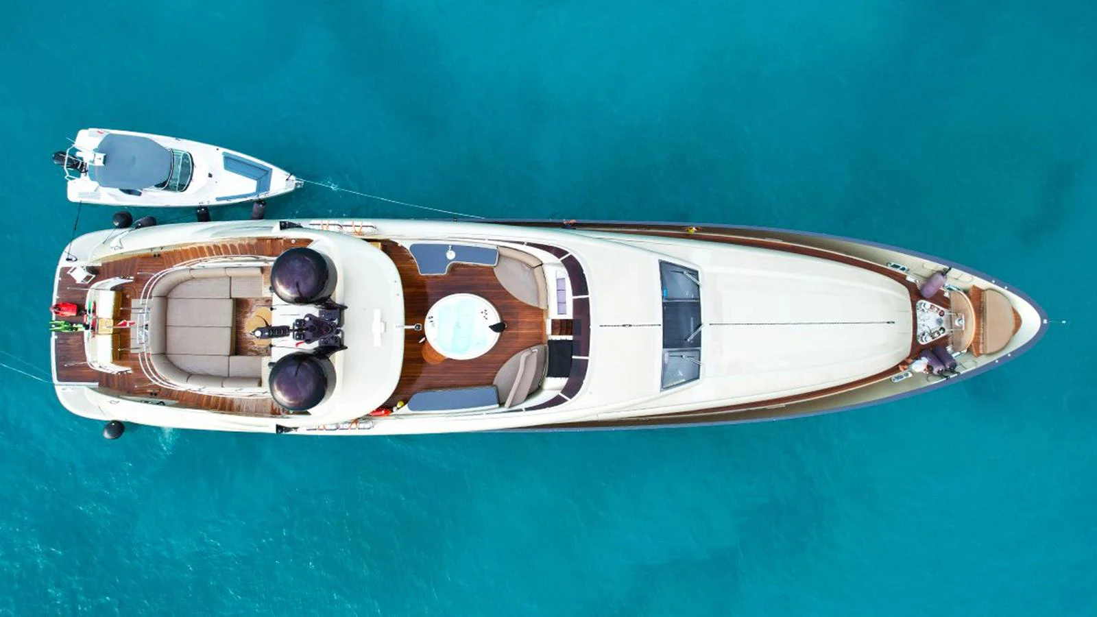 Aerial view of a sleek yacht cruising through clear blue waters. aboard YCM 120 Yacht for Sale