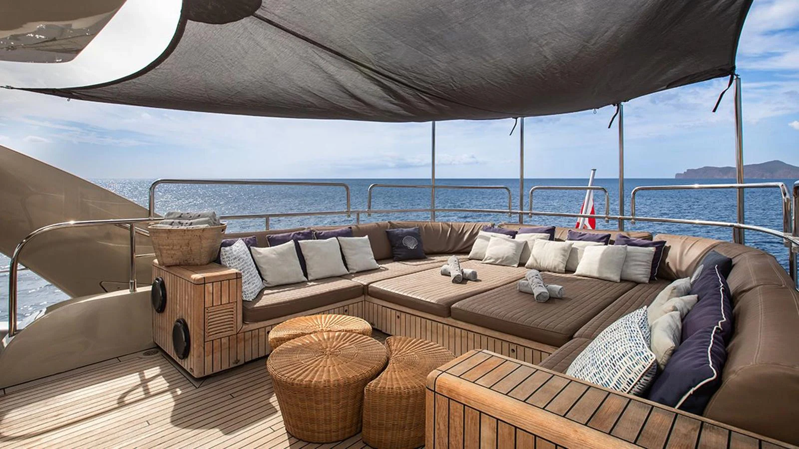 The aft deck features a spacious lounging area with comfortable seating and stunning ocean views. aboard YCM 120 Yacht for Sale