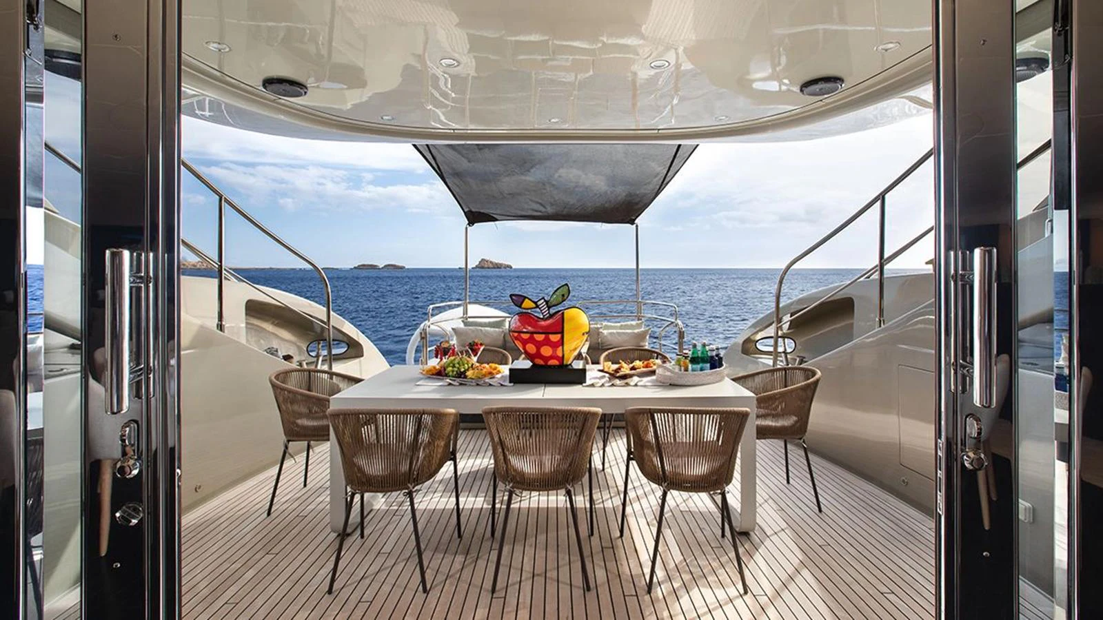 The aft deck features an elegant dining area with a stunning ocean view. aboard YCM 120 Yacht for Sale