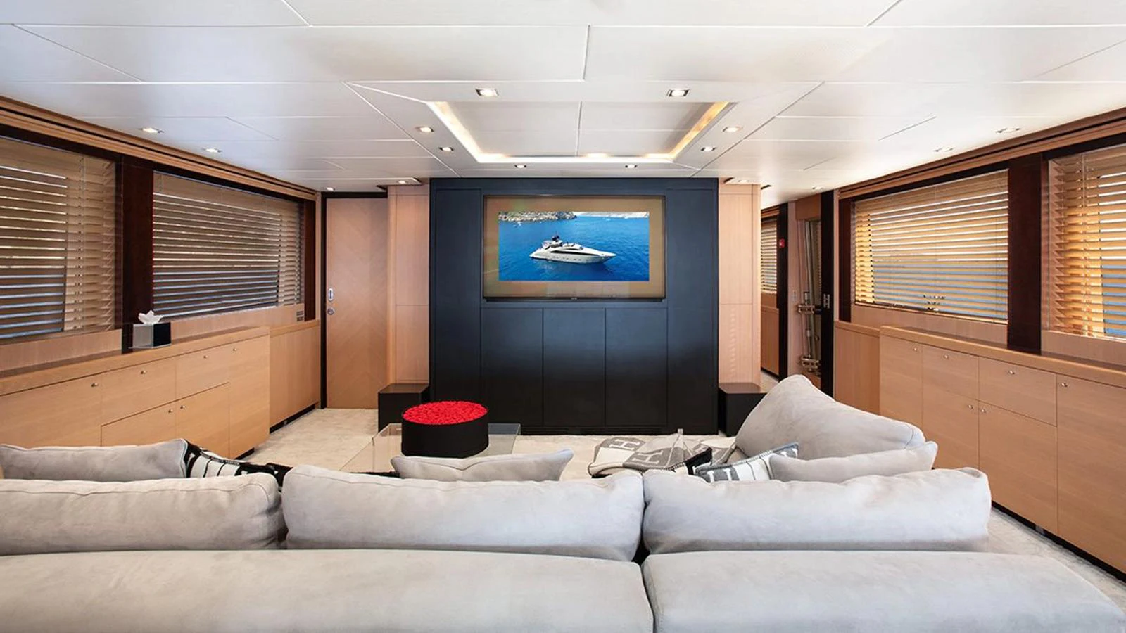 The salon features a spacious and modern design with comfortable seating and a large TV. aboard YCM 120 Yacht for Sale