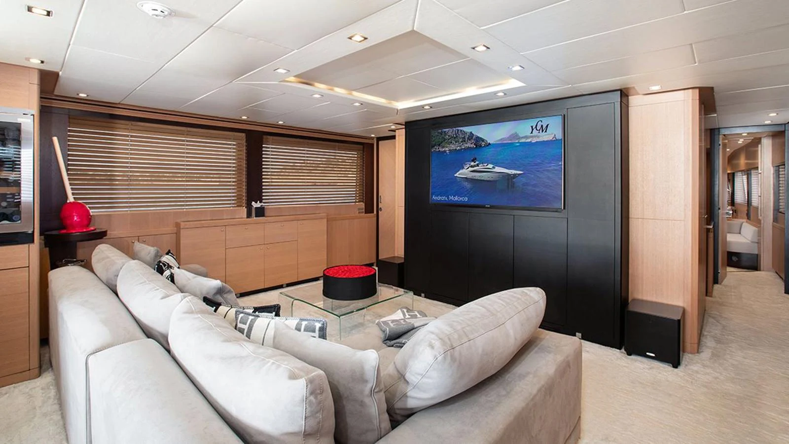 The salon features a spacious seating area with a large TV and modern decor. aboard YCM 120 Yacht for Sale