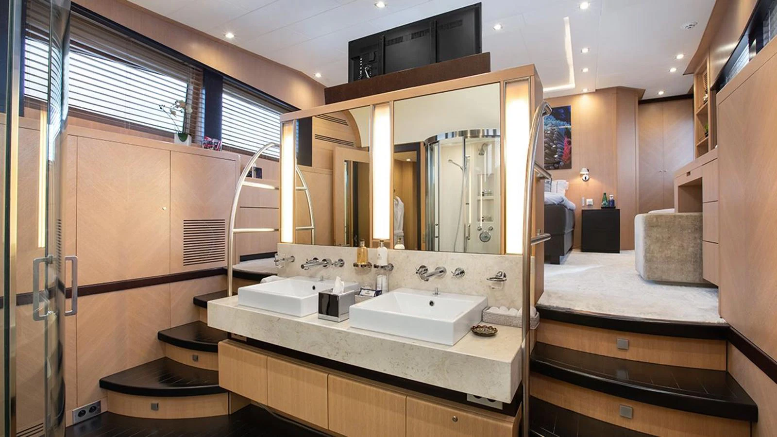 The master stateroom features a luxurious ensuite bathroom with dual sinks and modern fixtures. aboard YCM 120 Yacht for Sale