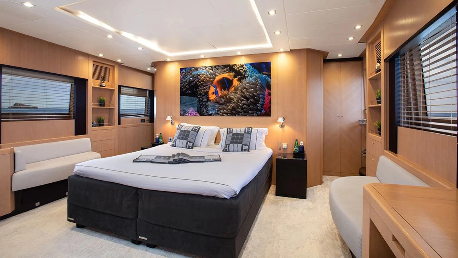 The master stateroom features a spacious bed, modern decor, and ample natural light. aboard YCM 120 Yacht for Sale