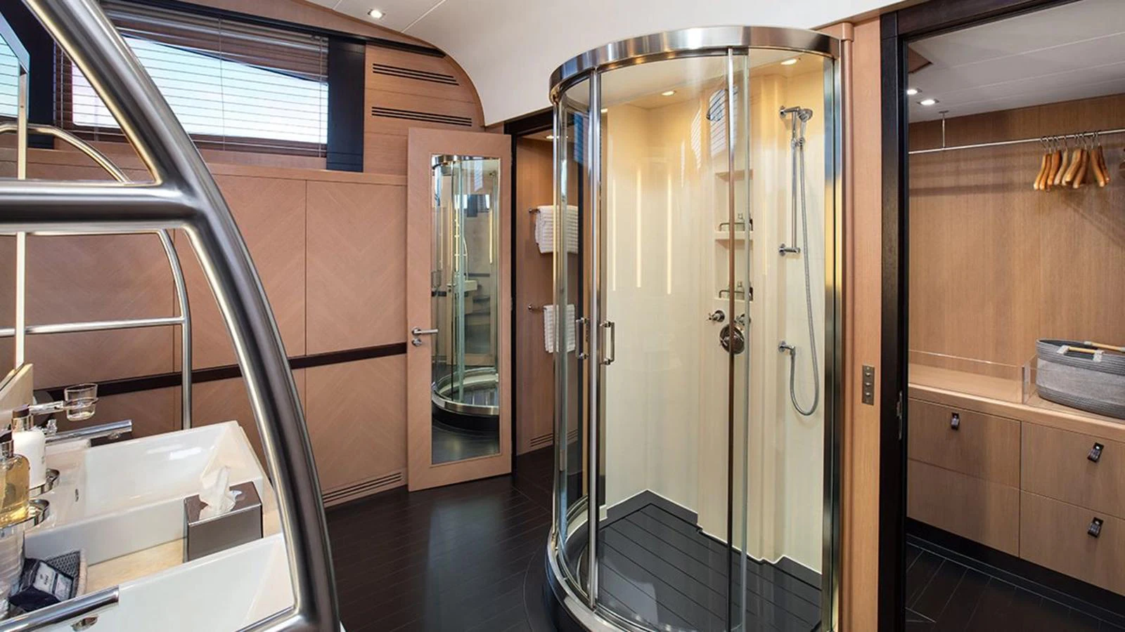 The yacht's bathroom features a modern circular shower and elegant fixtures. aboard YCM 120 Yacht for Sale