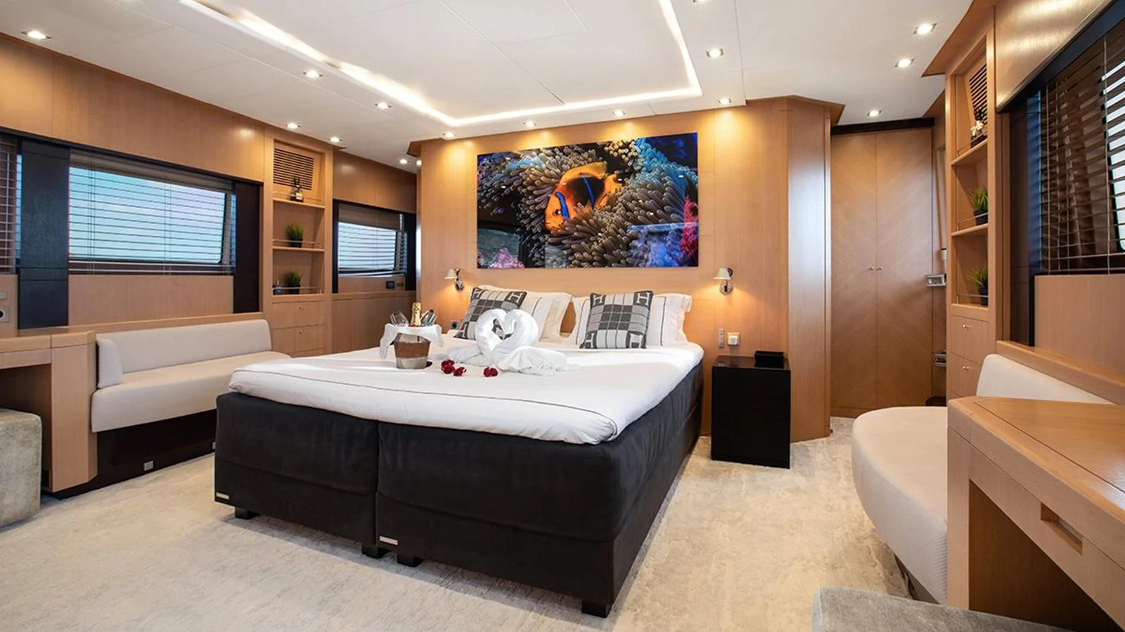 The master stateroom features a spacious bed, modern decor, and ample natural light. aboard YCM 120 Yacht for Sale