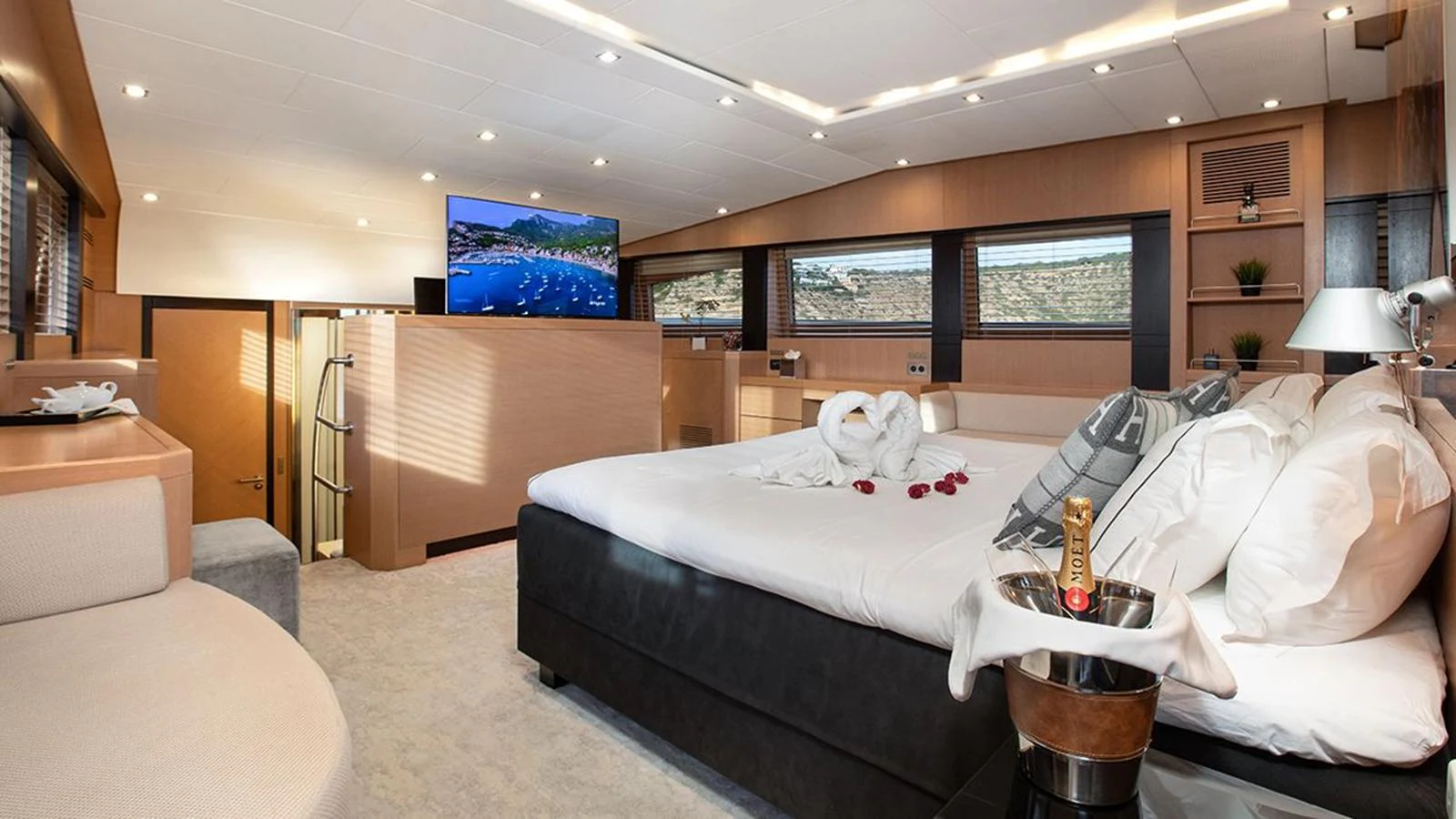 The master stateroom features a luxurious bed, modern decor, and a flat-screen TV for ultimate comfort. aboard YCM 120 Yacht for Sale