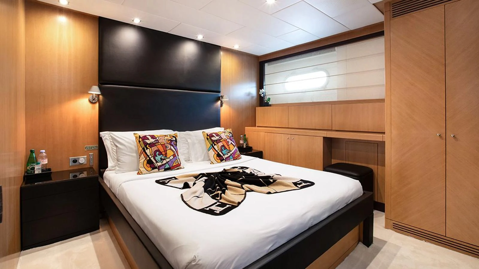 A luxurious stateroom featuring a large bed with elegant decor and ample storage space. aboard YCM 120 Yacht for Sale