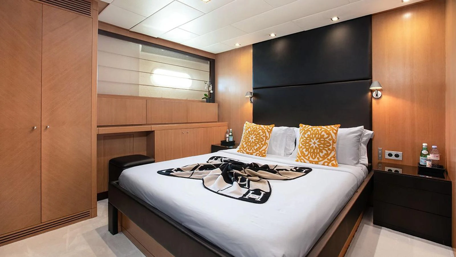 The stateroom features a luxurious bed with elegant decor and ample storage space. aboard YCM 120 Yacht for Sale