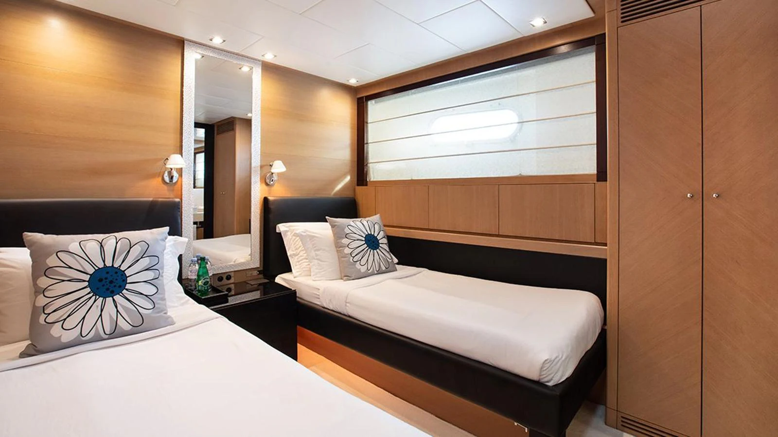 The guest stateroom features twin beds with modern decor and ample storage. aboard YCM 120 Yacht for Sale
