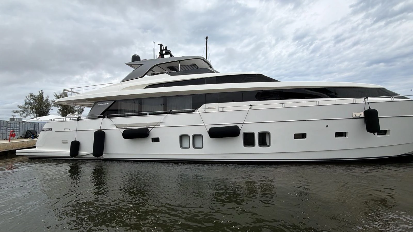 A sleek and modern yacht is docked at the marina, showcasing its elegant design. aboard HONEY Yacht for Sale