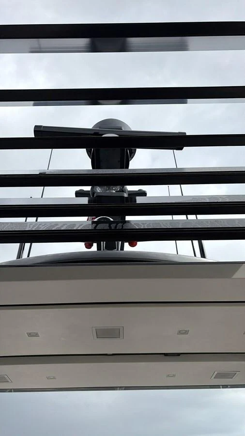 A close-up view of the yacht's radar and communication equipment against a cloudy sky. aboard HONEY Yacht for Sale