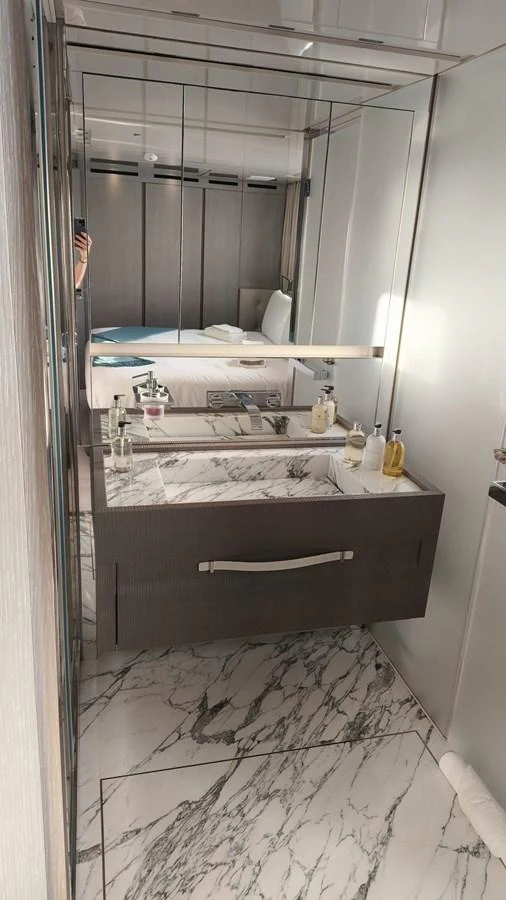 A sleek bathroom with a marble countertop and modern fixtures. aboard HONEY Yacht for Sale