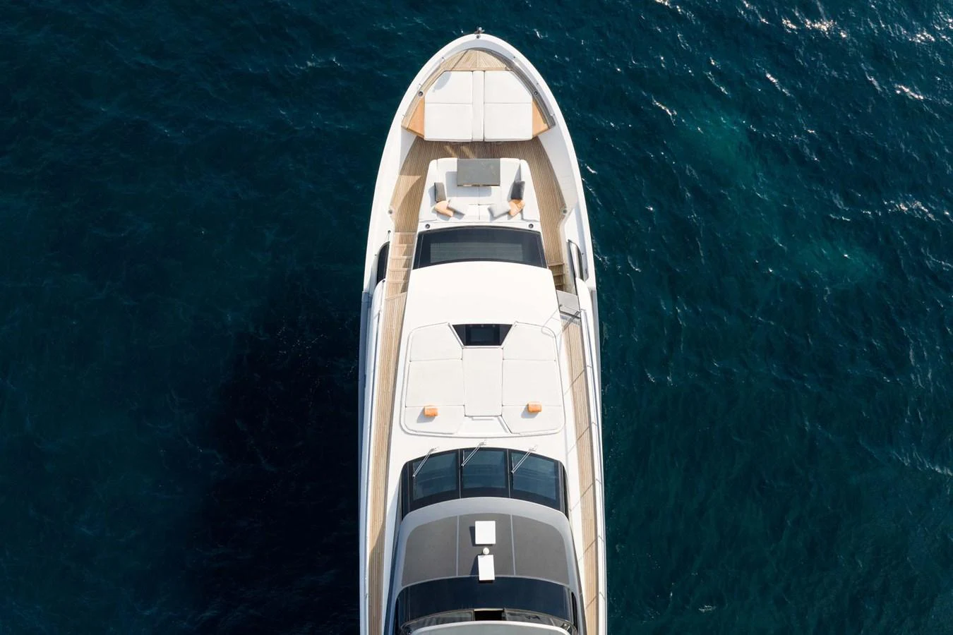 An aerial view of a sleek yacht cruising on deep blue waters. aboard JACKI 8 Yacht for Sale