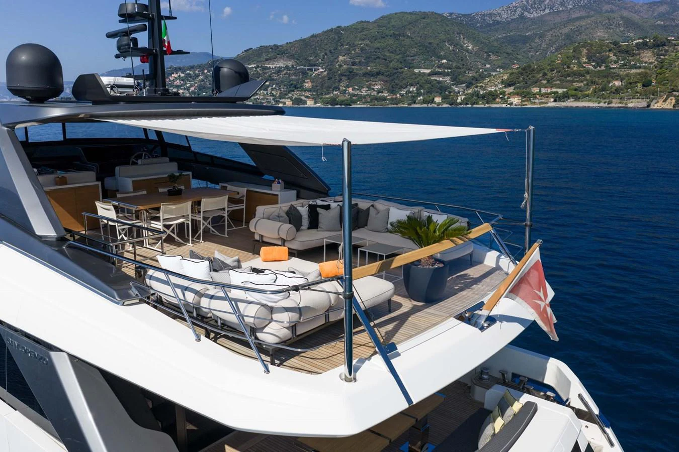 The yacht's sundeck offers a luxurious outdoor living space with ample seating and stunning views. aboard JACKI 8 Yacht for Sale
