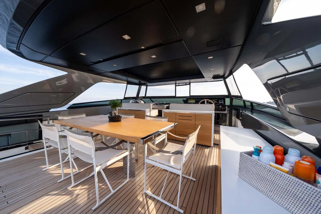 The flybridge features a spacious dining area with a sleek, modern design. aboard JACKI 8 Yacht for Sale