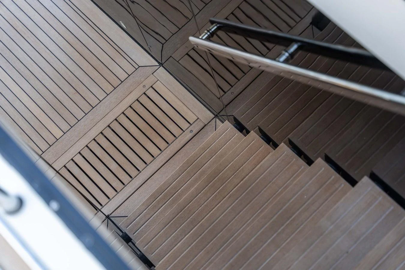 A close-up view of the yacht's elegant wooden staircase and deck. aboard JACKI 8 Yacht for Sale