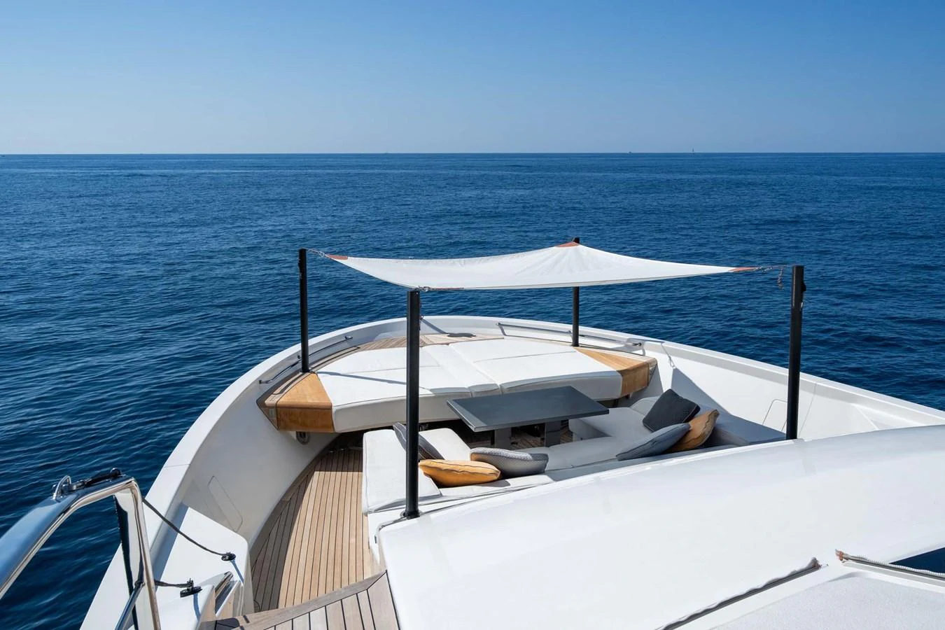 The foredeck features a shaded lounging area with comfortable seating and a table, perfect for relaxation. aboard JACKI 8 Yacht for Sale