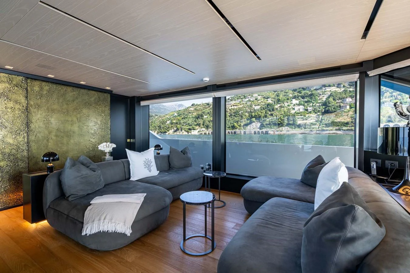 The salon features plush seating with panoramic windows offering stunning views. aboard JACKI 8 Yacht for Sale