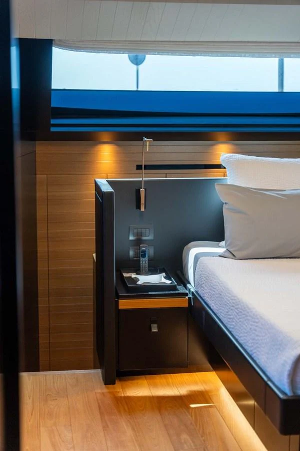 The stateroom features a modern design with warm wood accents and soft lighting. aboard JACKI 8 Yacht for Sale