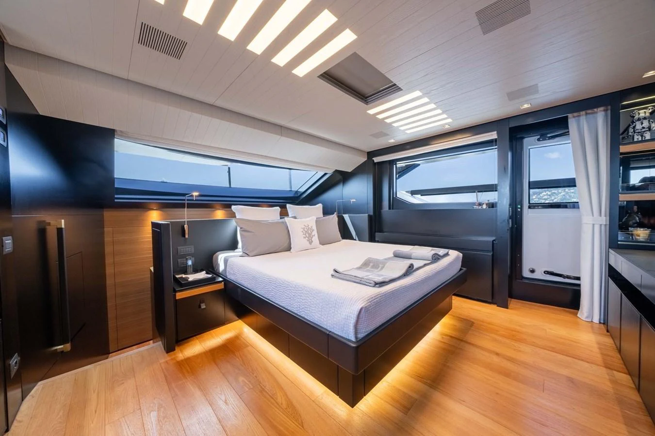 A luxurious stateroom featuring modern design and ample natural light. aboard JACKI 8 Yacht for Sale
