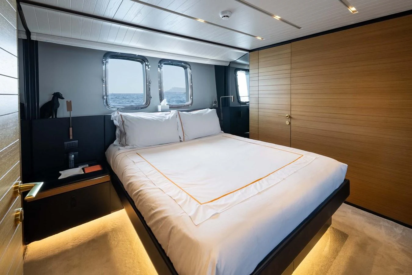 The stateroom features a luxurious bed with elegant bedding and modern design elements. aboard JACKI 8 Yacht for Sale