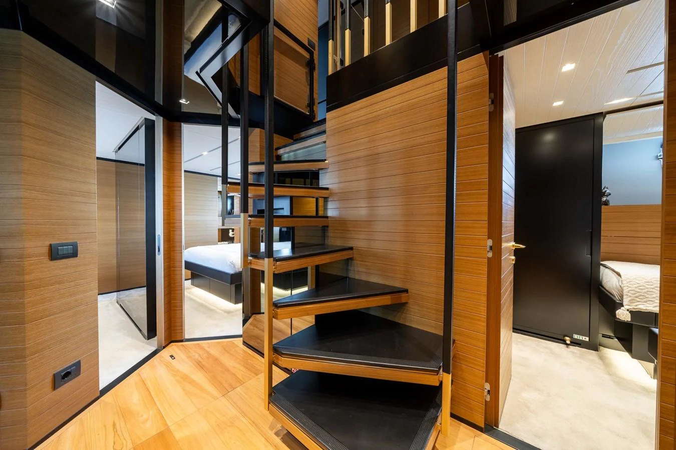 The image showcases a modern yacht interior with a sleek staircase leading to the upper deck. aboard JACKI 8 Yacht for Sale