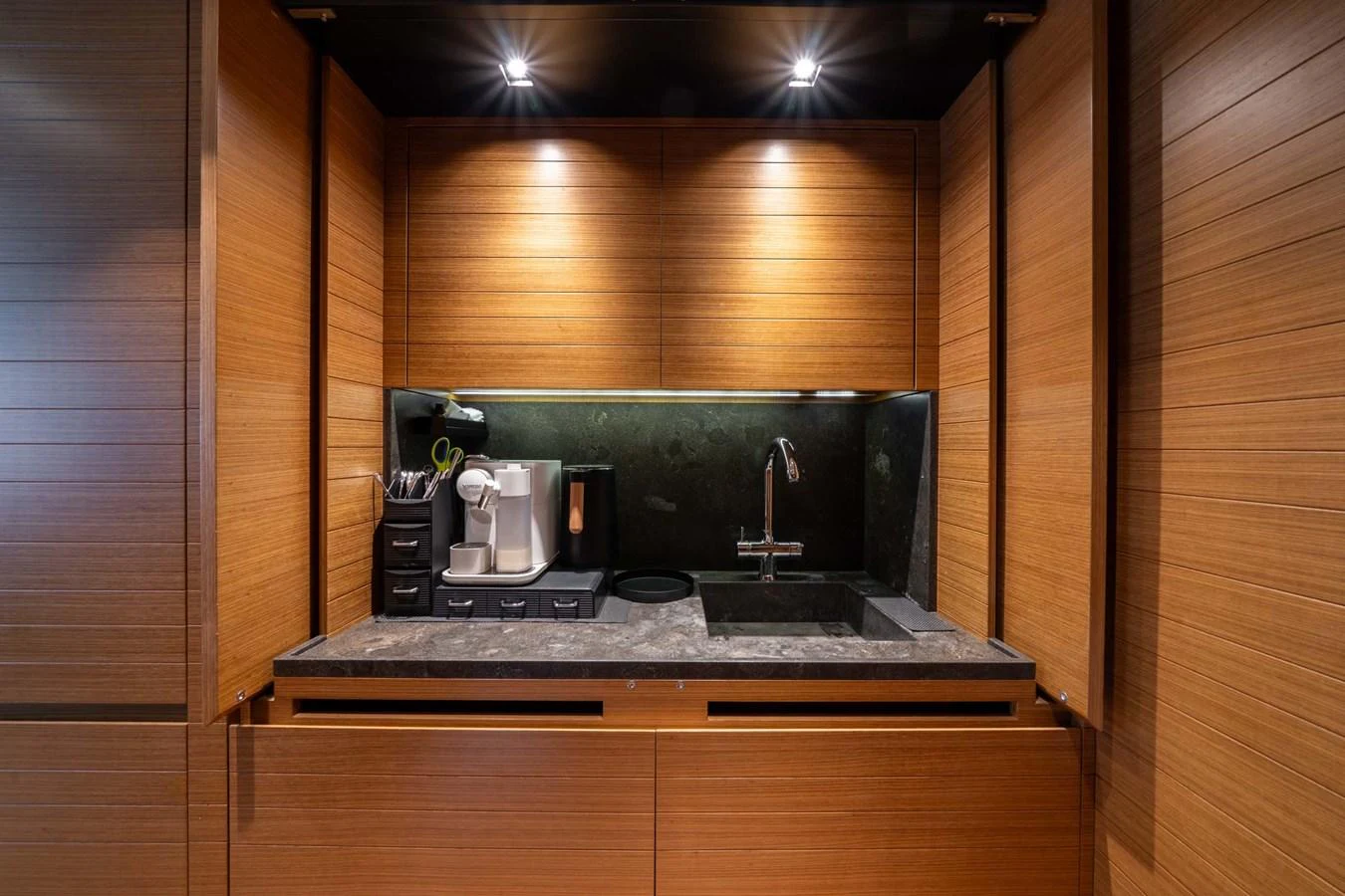 The yacht's galley features modern appliances and sleek wooden cabinetry. aboard JACKI 8 Yacht for Sale